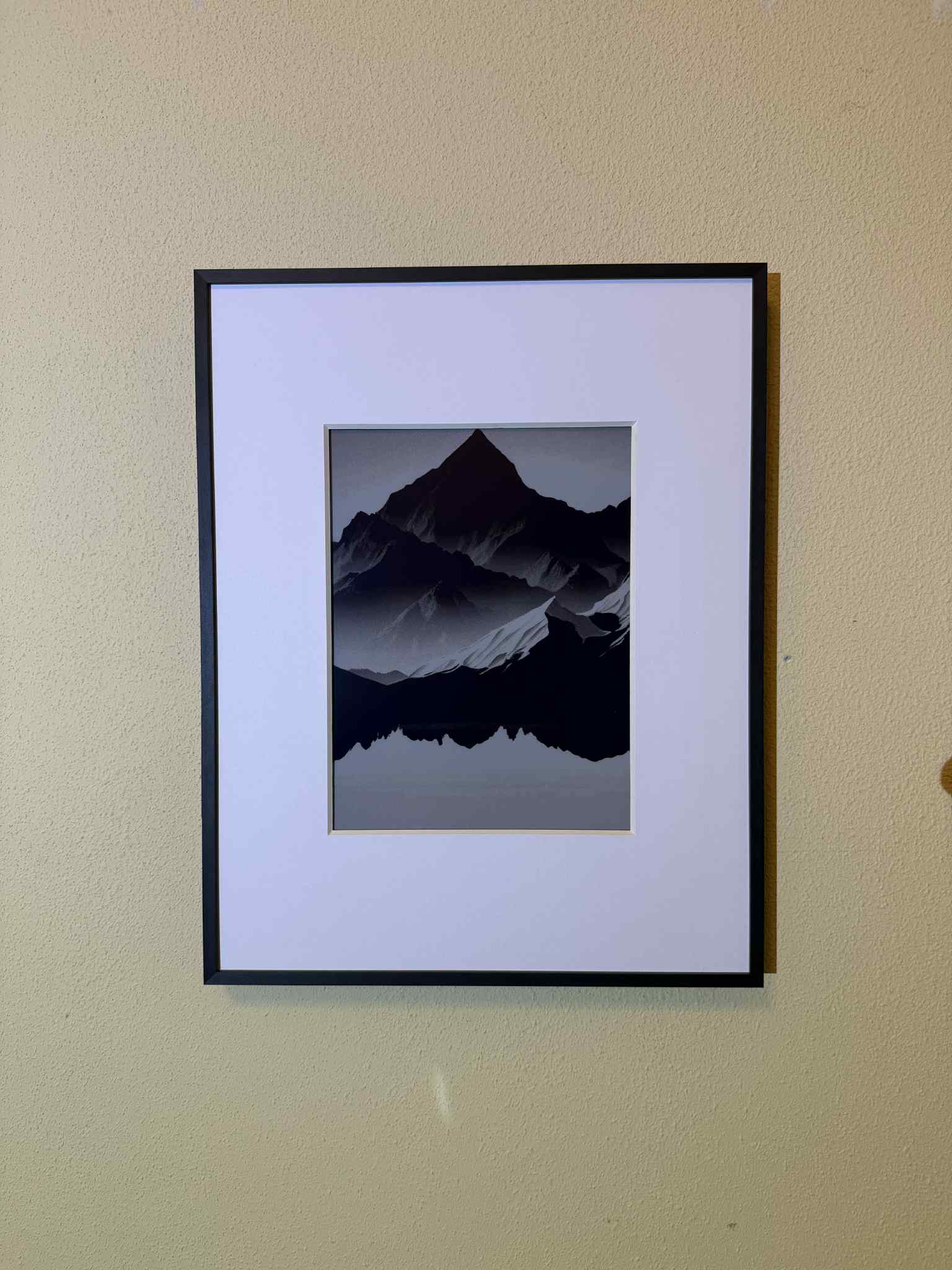 Black and white mountain graphic displayed on the Aluratek ePaper frame