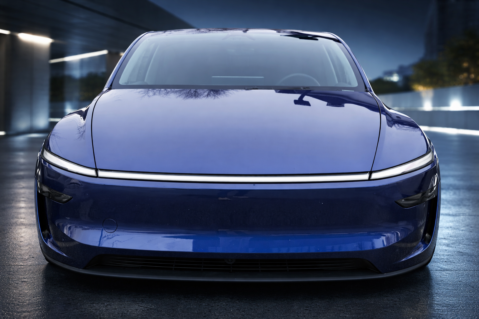 Futuristic blue Tesla Model Y Juniper at twilight for Tesla FSD HW4 review