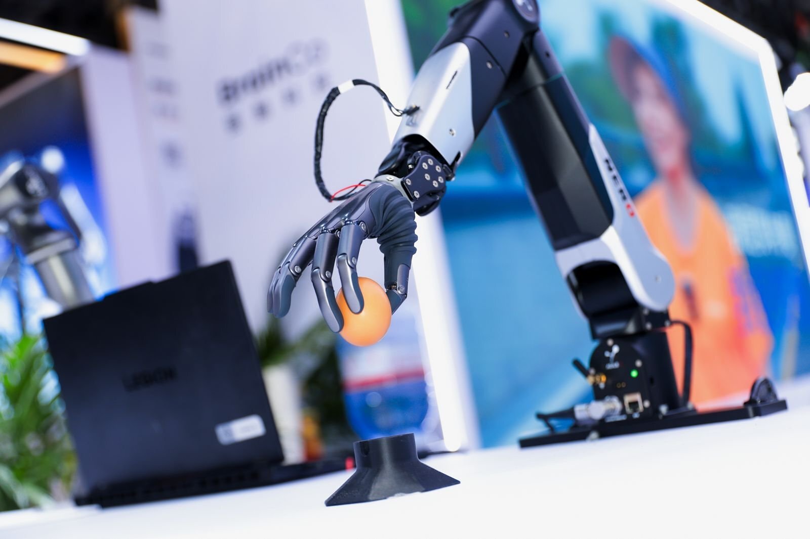 BrainCo robot hand grasping an apple during the company's WAIC 2026 brain-to-robot demonstration